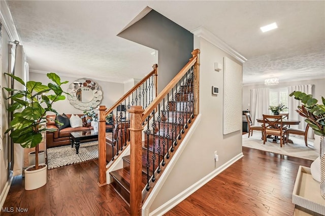 4815 Shadow Oak Dr, Austintown, OH 44515 - stairs featuring wood finished floors, ornamental molding, a textured ceiling, and baseboards