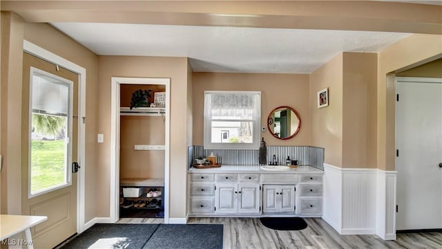 entryway with a sink and light wood-style flooring