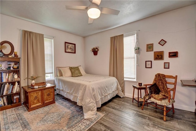 bedroom with wood finished floors, ceiling fan, and baseboards