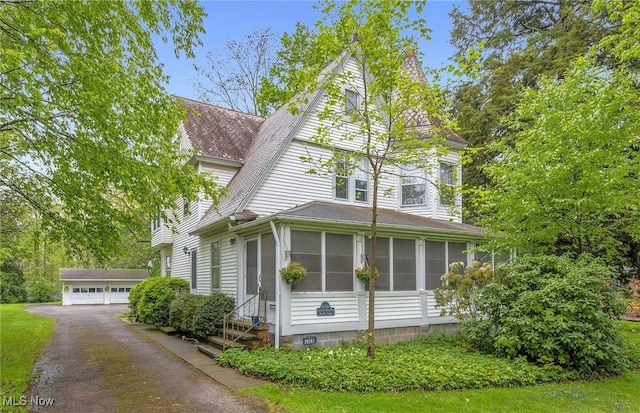 26561 Butternut Ridge Rd, North Olmsted, OH 44070 - view of front of house featuring an outdoor structure, a garage, a sunroom, and a shingled roof