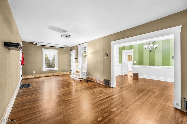 26561 Butternut Ridge Rd, North Olmsted, OH 44070 - unfurnished living room featuring a chandelier, wood-type flooring, and baseboards