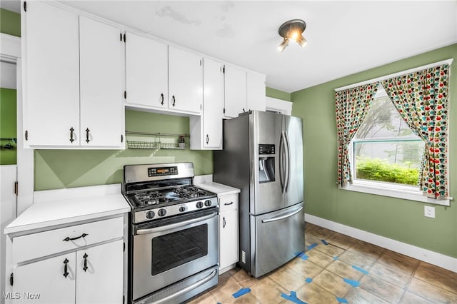 26561 Butternut Ridge Rd, North Olmsted, OH 44070 - kitchen with appliances with stainless steel finishes, light countertops, white cabinets, baseboards, and light tile patterned floors