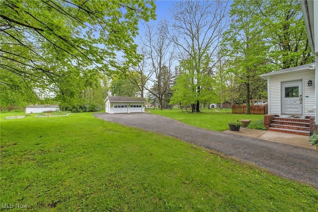 26561 Butternut Ridge Rd, North Olmsted, OH 44070 - view of yard with a detached garage and an outbuilding