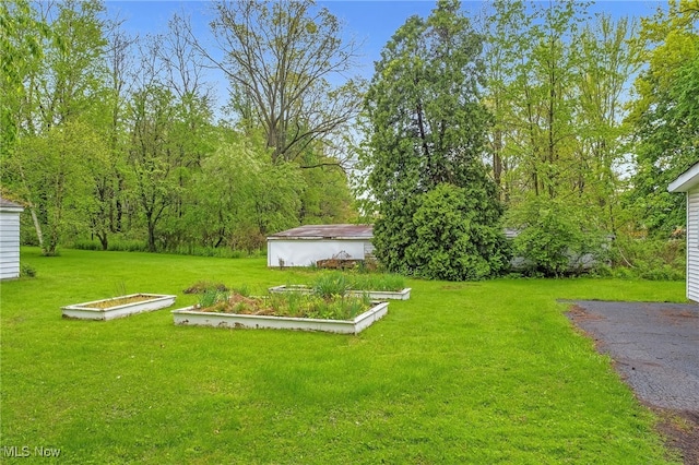 26561 Butternut Ridge Rd, North Olmsted, OH 44070 - view of green lawn featuring a garden