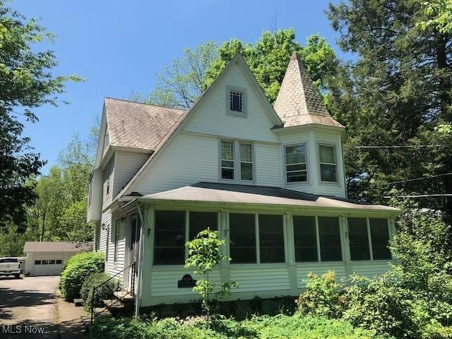 26561 Butternut Ridge Rd, North Olmsted, OH 44070 - view of property exterior with a sunroom and roof with shingles