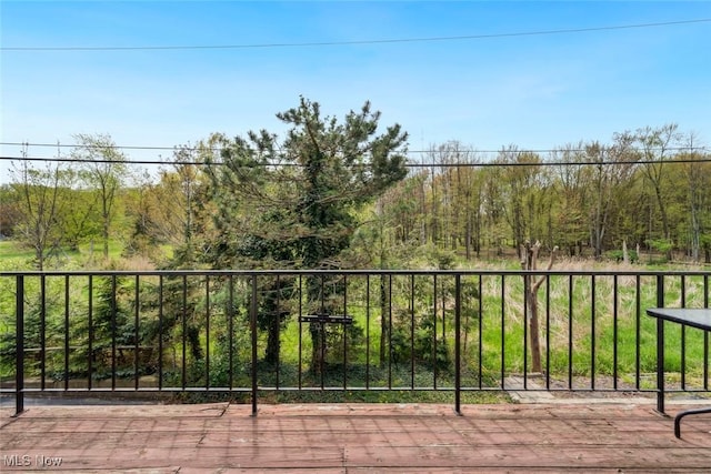 view of patio / terrace featuring a deck and a forest view