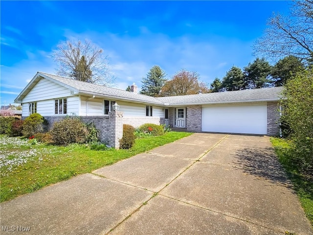 single story home featuring brick siding, a garage, driveway, a chimney, and a front yard