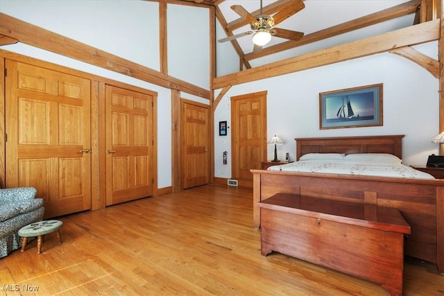 70 Northlake Ct, Vincent, OH 45784 - bedroom with high vaulted ceiling, wood finished floors, beam ceiling, two closets, and a ceiling fan
