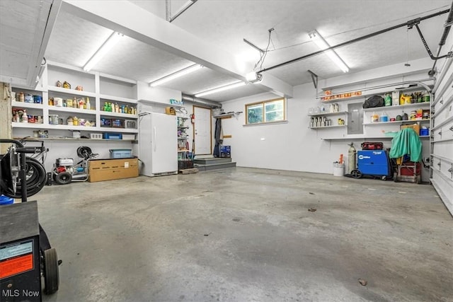 70 Northlake Ct, Vincent, OH 45784 - garage with a garage door opener, freestanding refrigerator, and electric panel