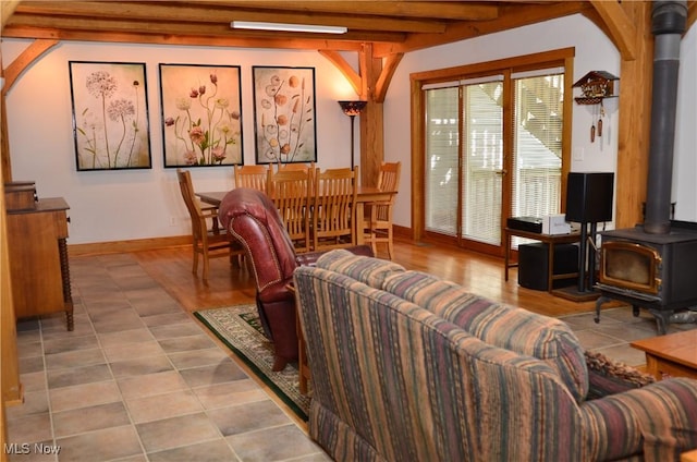 70 Northlake Ct, Vincent, OH 45784 - tiled living room with a wood stove, beamed ceiling, and baseboards