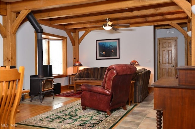 70 Northlake Ct, Vincent, OH 45784 - living room with a wood stove, ceiling fan, and beam ceiling