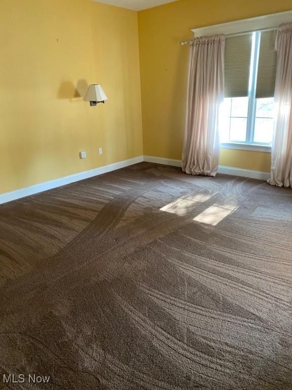 empty room with carpet flooring and baseboards