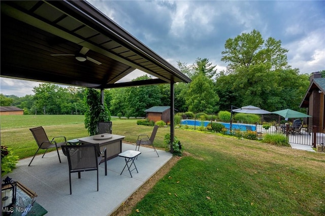 55901 Deep Run Rd, Martins Ferry, OH 43935 - view of yard featuring a patio area, a storage unit, a ceiling fan, an outdoor pool, and an outdoor structure