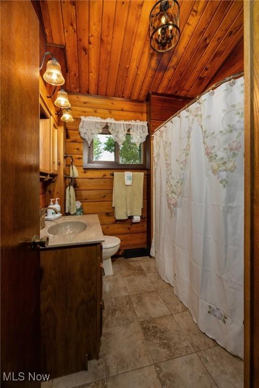 55901 Deep Run Rd, Martins Ferry, OH 43935 - full bathroom featuring wood ceiling, vanity, toilet, and wooden walls