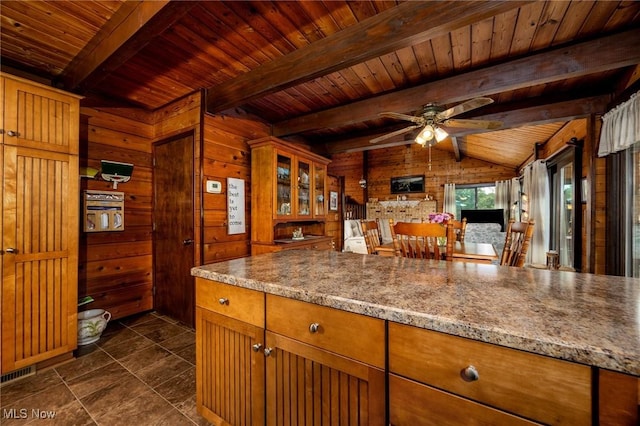 55901 Deep Run Rd, Martins Ferry, OH 43935 - kitchen with wooden ceiling, wooden walls, ceiling fan, brown cabinetry, and glass insert cabinets