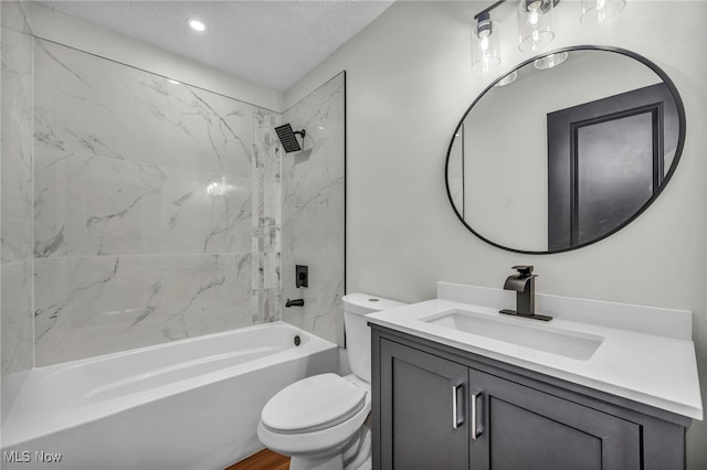 full bath featuring toilet, vanity, bathtub / shower combination, a textured ceiling, and recessed lighting