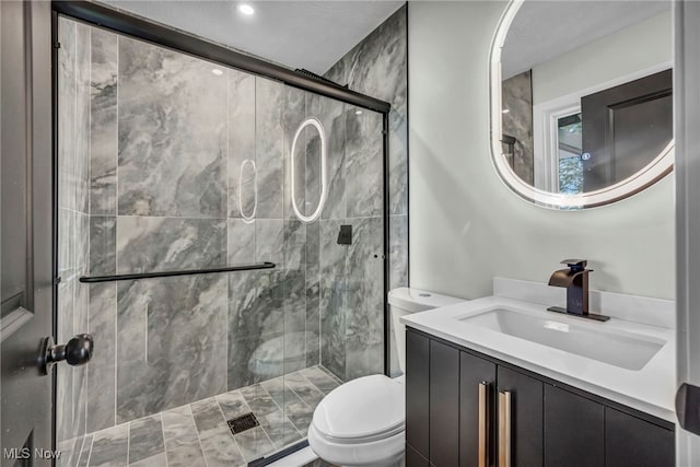bathroom with toilet, a shower stall, vanity, and recessed lighting