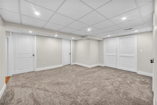 finished basement with carpet, recessed lighting, baseboards, and a paneled ceiling