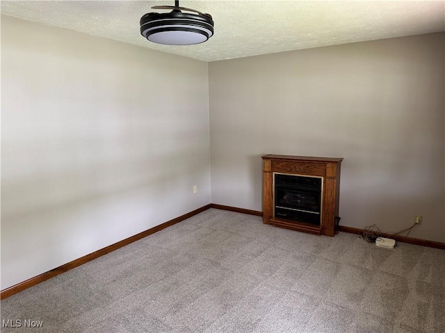 402 Washington Dr, Mineral Wells, WV 26150 - unfurnished living room with light carpet, baseboards, a fireplace, and a textured ceiling