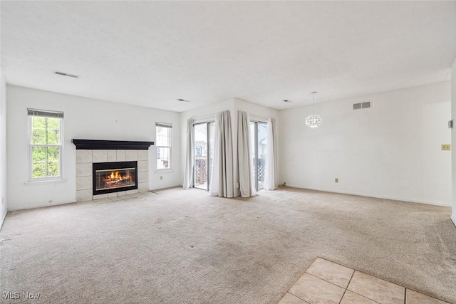 1328 Cedarwood Dr Unit A3, Westlake, OH 44145 - unfurnished living room with carpet floors, a tiled fireplace, and baseboards