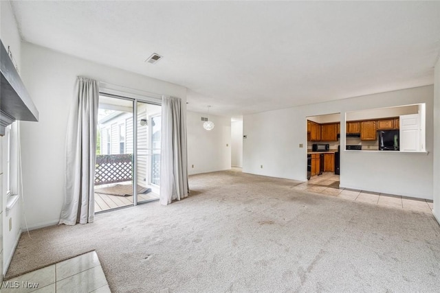 1328 Cedarwood Dr Unit A3, Westlake, OH 44145 - unfurnished living room with light colored carpet, light tile patterned floors, and baseboards