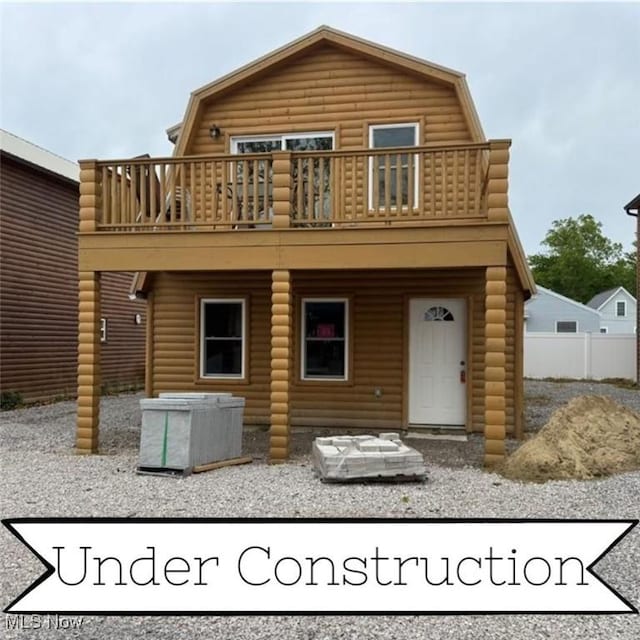 5919 Lake Rd W Unit 31, Ashtabula, OH 44004 - back of property with a gambrel roof, faux log siding, and a balcony