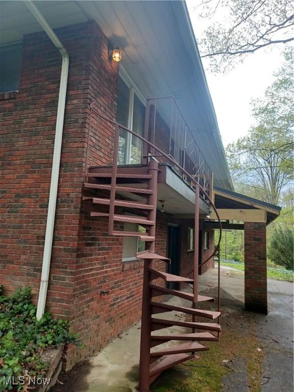 1050 Park Cir, Girard, OH 44420 - view of home's exterior with brick siding and stairs