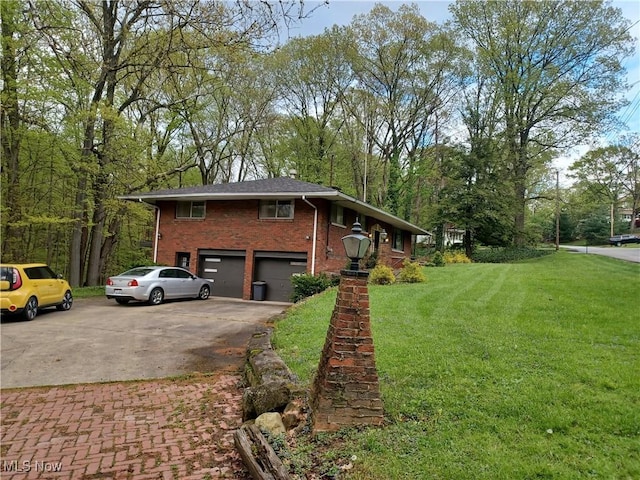 1050 Park Cir, Girard, OH 44420 - view of front of property featuring a garage, driveway, brick siding, and a front yard