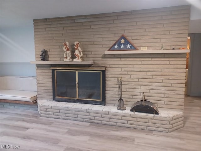 1050 Park Cir, Girard, OH 44420 - detailed view of a brick fireplace, wood finished floors, and wainscoting