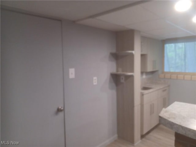 1050 Park Cir, Girard, OH 44420 - kitchen with white cabinetry, light countertops, and light wood finished floors