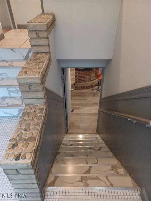 1050 Park Cir, Girard, OH 44420 - staircase featuring wood finished floors and a fireplace