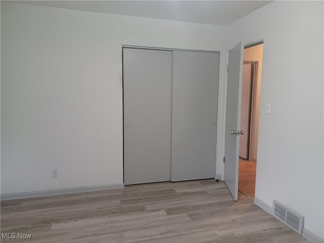 1050 Park Cir, Girard, OH 44420 - unfurnished bedroom with a closet and light wood finished floors