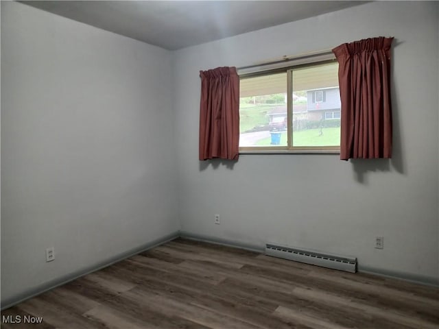 1050 Park Cir, Girard, OH 44420 - spare room featuring a baseboard radiator and wood finished floors