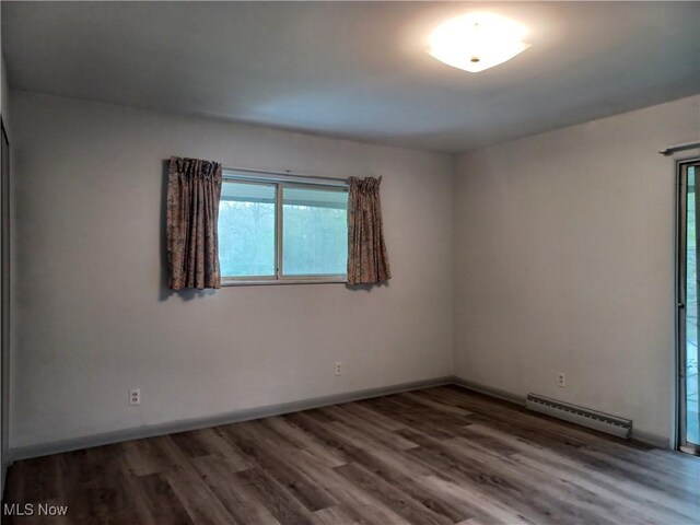 1050 Park Cir, Girard, OH 44420 - spare room featuring a baseboard radiator, wood finished floors, and baseboards