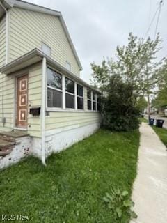 view of property exterior with a yard