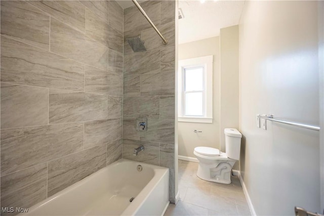 bathroom with toilet, baseboards, tile patterned flooring, and shower / bath combination