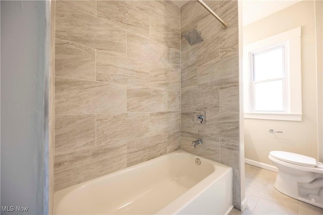full bath featuring toilet, baseboards, and shower / tub combination