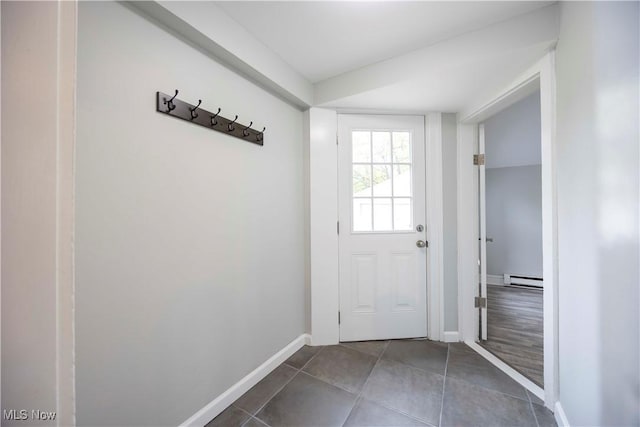 doorway to outside with tile patterned floors, baseboards, and a baseboard heating unit