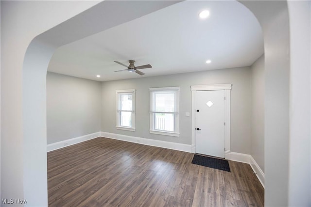 entryway with a ceiling fan, dark wood-style floors, baseboards, recessed lighting, and arched walkways