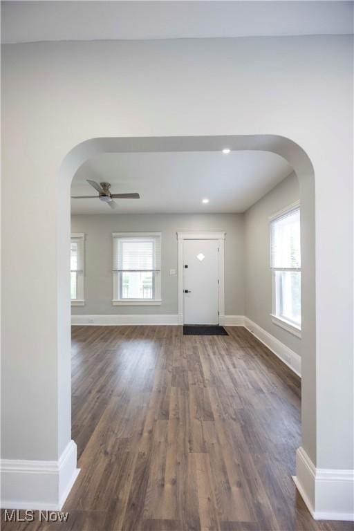 entrance foyer with arched walkways, baseboards, ceiling fan, dark wood-style flooring, and recessed lighting