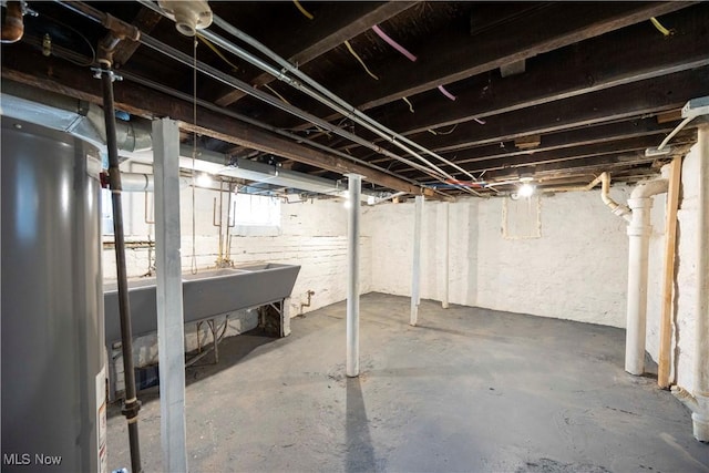 below grade area with water heater and a sink