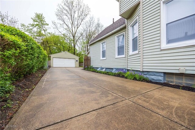 view of side of property with a garage and an outdoor structure