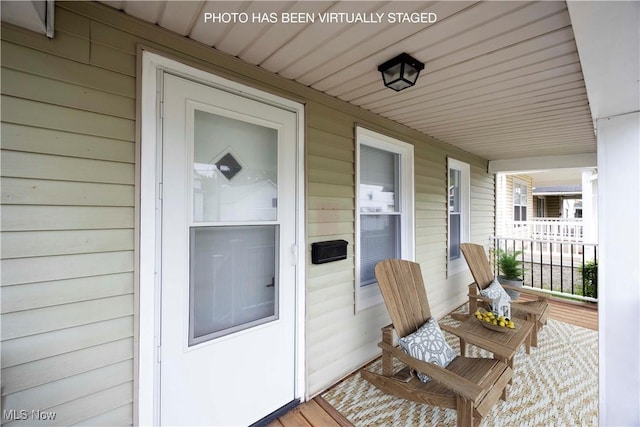entrance to property featuring a porch