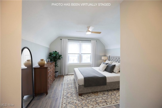 bedroom with lofted ceiling, wood finished floors, ceiling fan, and baseboards