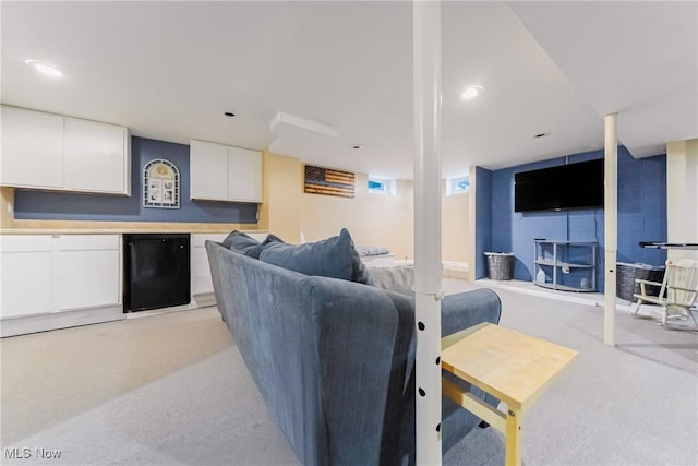 living area featuring light carpet