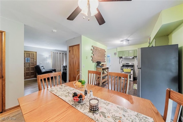 dining room with ceiling fan and light wood-type flooring