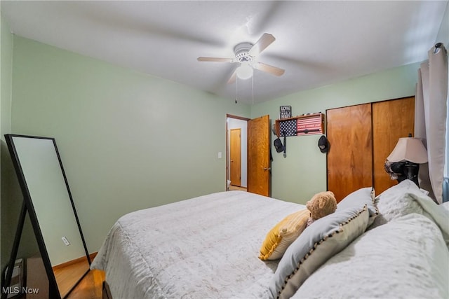 bedroom featuring a ceiling fan, wood finished floors, and baseboards