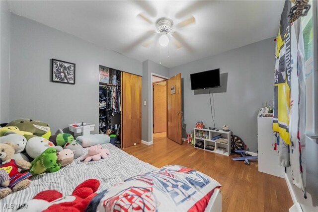 bedroom with wood finished floors, a closet, and a ceiling fan