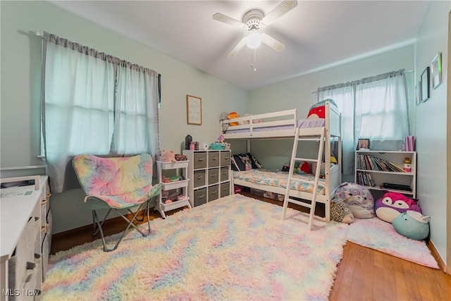 bedroom featuring hardwood / wood-style floors, ceiling fan, and baseboards