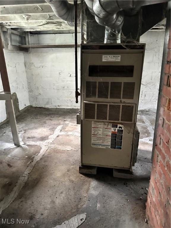 utility room featuring heating unit